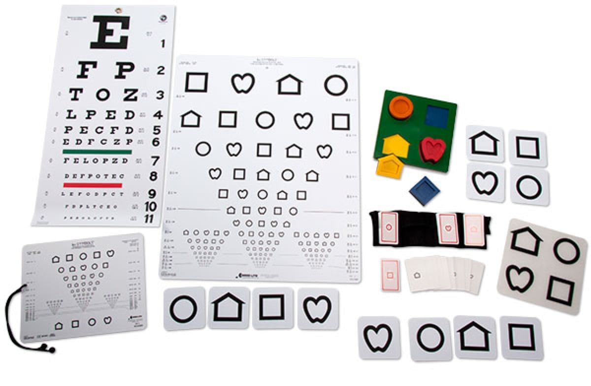 1-08149-02-NewT-Charts-with-measureing-cord A variety of acuity measurement charts, symbol cards, and a puzzle board laid out on a white background.