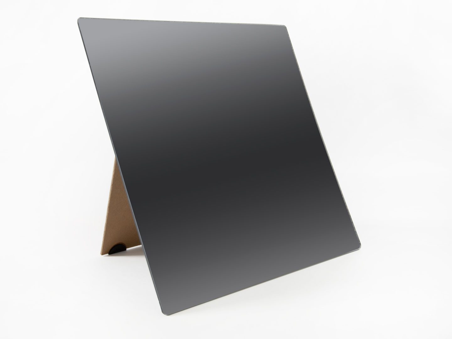 SLK-Mirror_DSC_3020_web A frameless mirror propped up on its brown stand sitting on a white background.