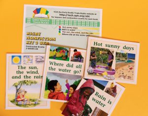 A collection of colorful books on a yellow surface.