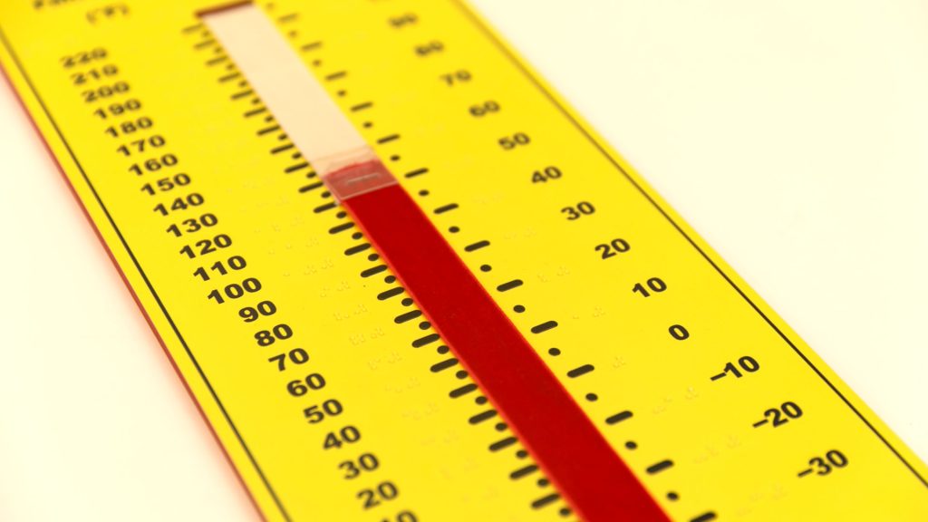 A bright yellow thermometer with braille and print numbers on the sides, and a red "mercury" strip running up the middle.