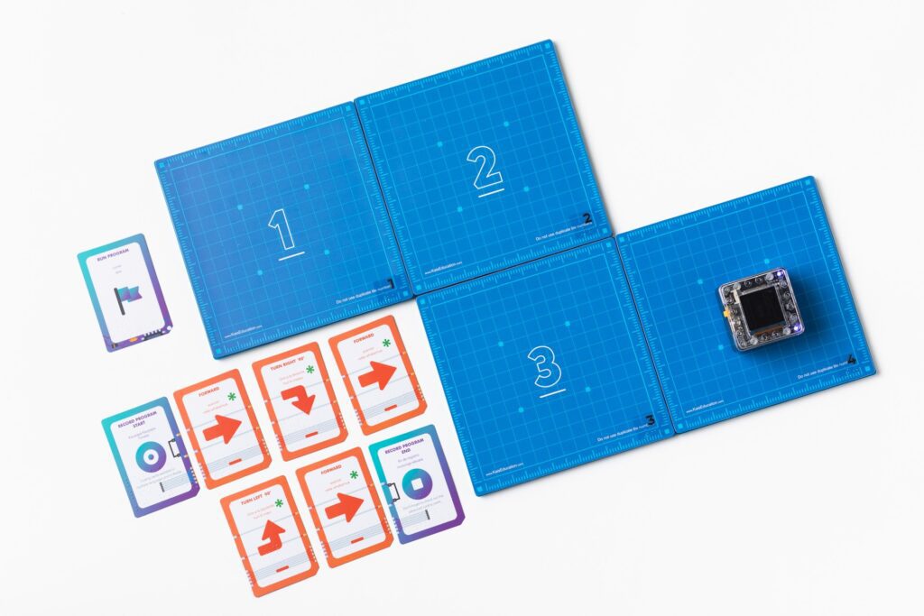 The KaiBot magnetic tiles arranged in a path next to coding tiles.